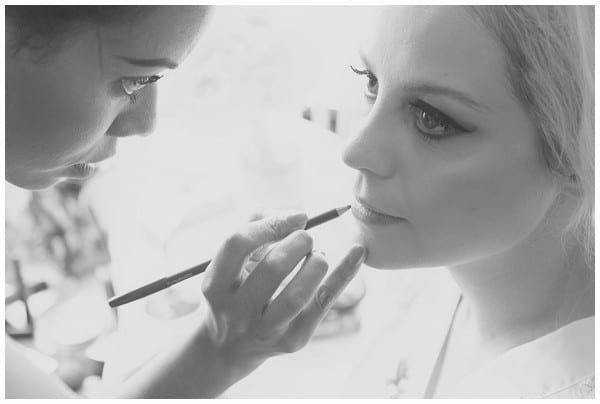 Bride having make up done by Leona Thompson