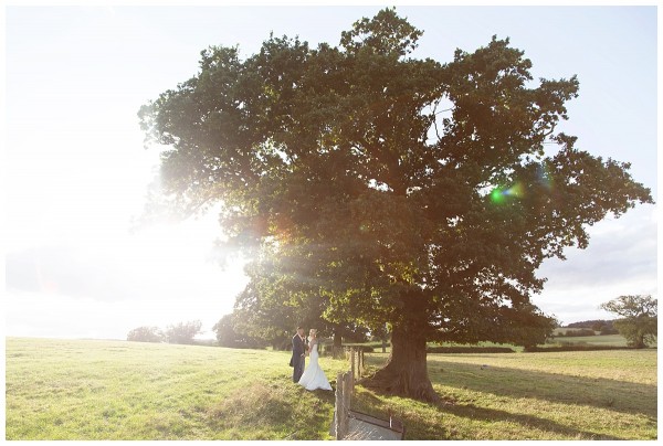 Bride and Groom under the tree at Bordesley Park Farm